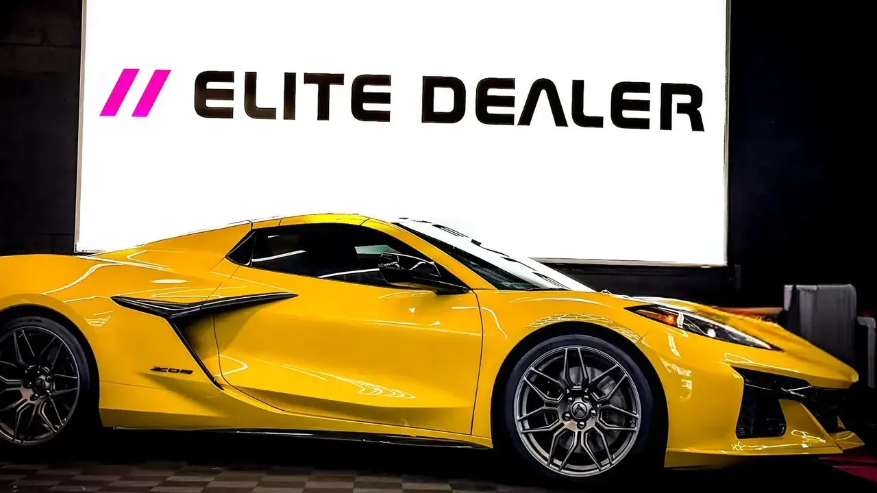 Yellow Corvette in front of the Ceramic Pro Elite Dealer banner at Ecophant Auto