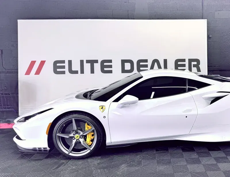 White Ferrari F8 in front of the Ceramic Pro Elite Dealer banner at Ecophant Auto