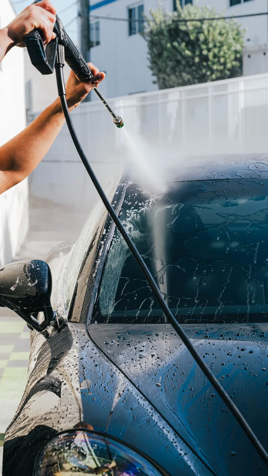 Technician washing a ceramic-coated car at Ecophant Auto