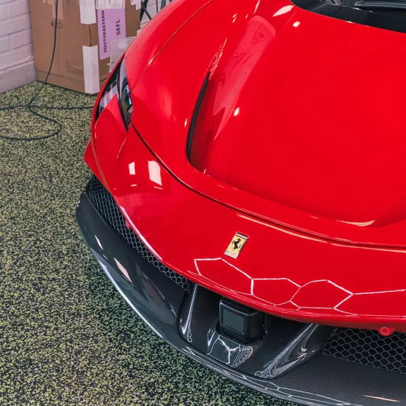 Carbon fiber body kit on a Ferrari, front detail, at Ecophant Auto Boca Raton