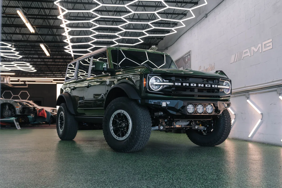 Green Ford Bronco with LED light bar and upgraded wheels at Ecophant Auto in Boca Raton