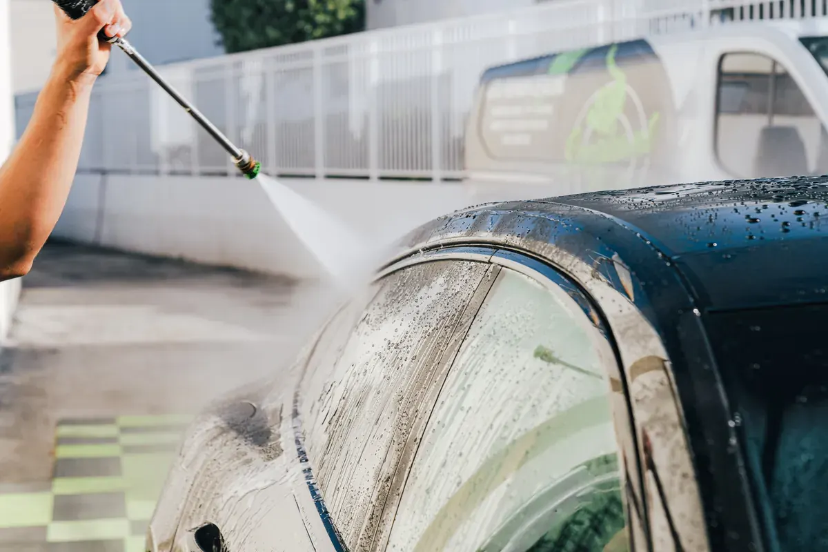Ecophant Auto technician pressure-washing a vehicle during auto detailing in Boca Raton